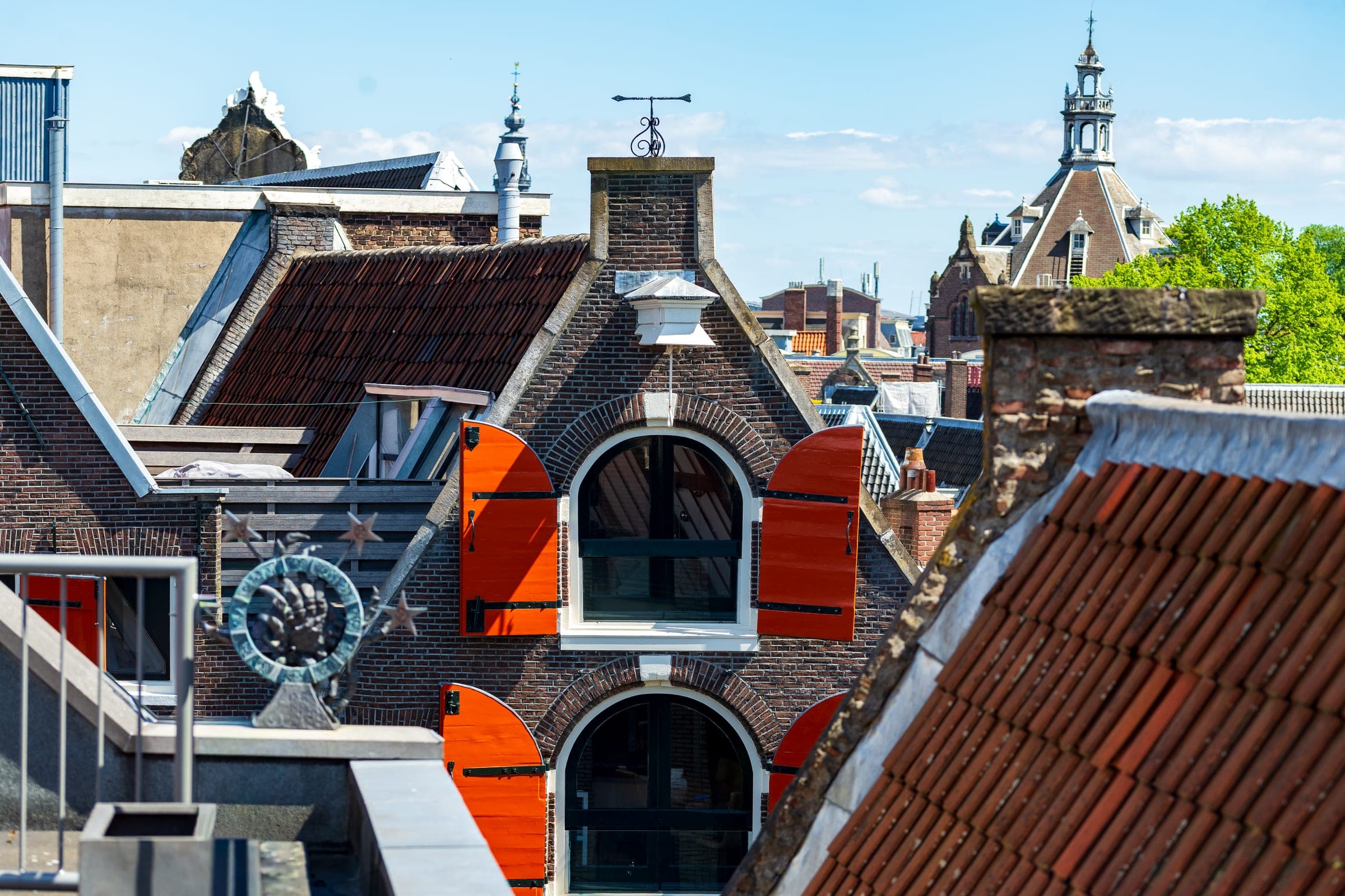 Orange shutters above Haarlem rooftops