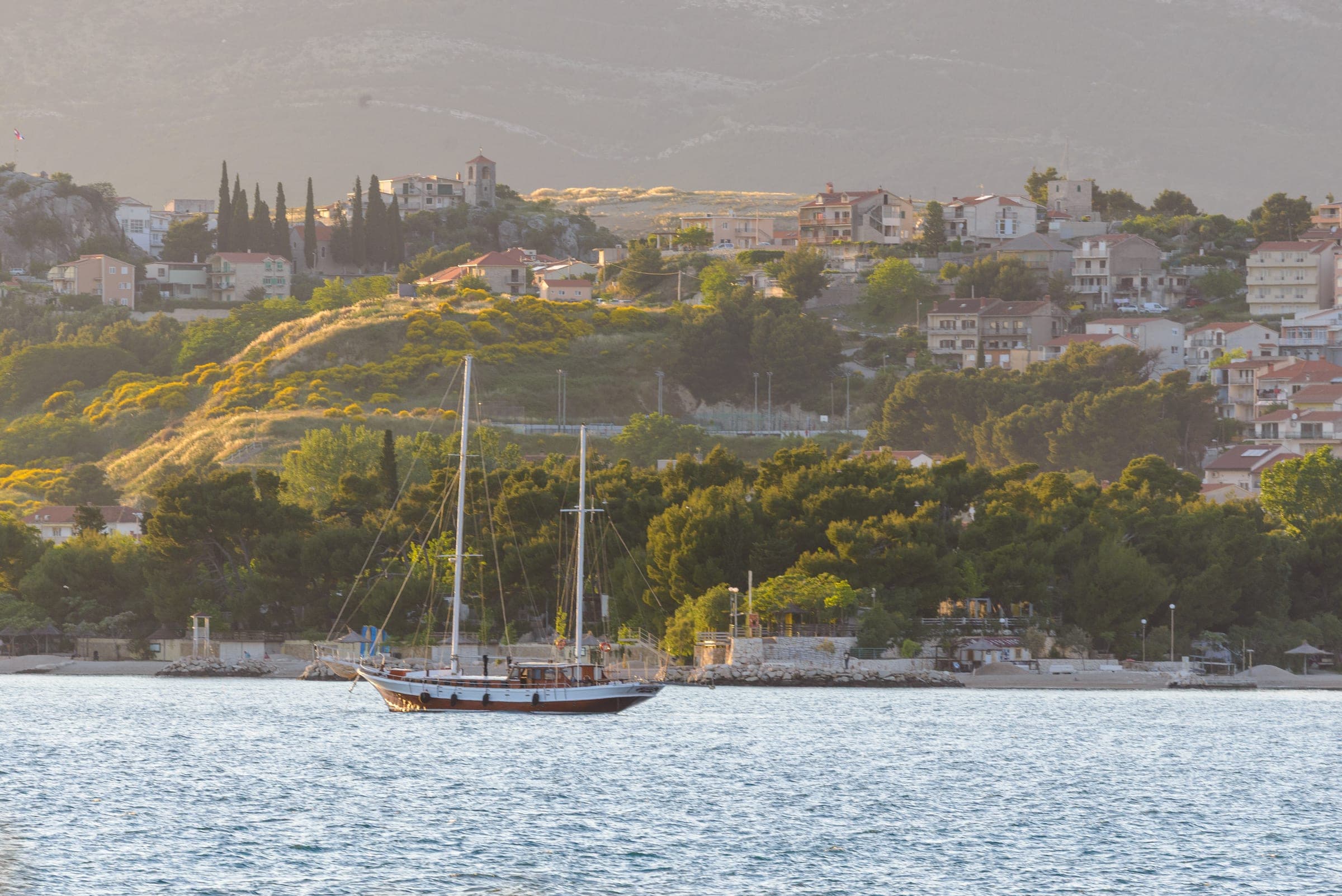 Gulet anchored off a sunlit Adriatic hillside