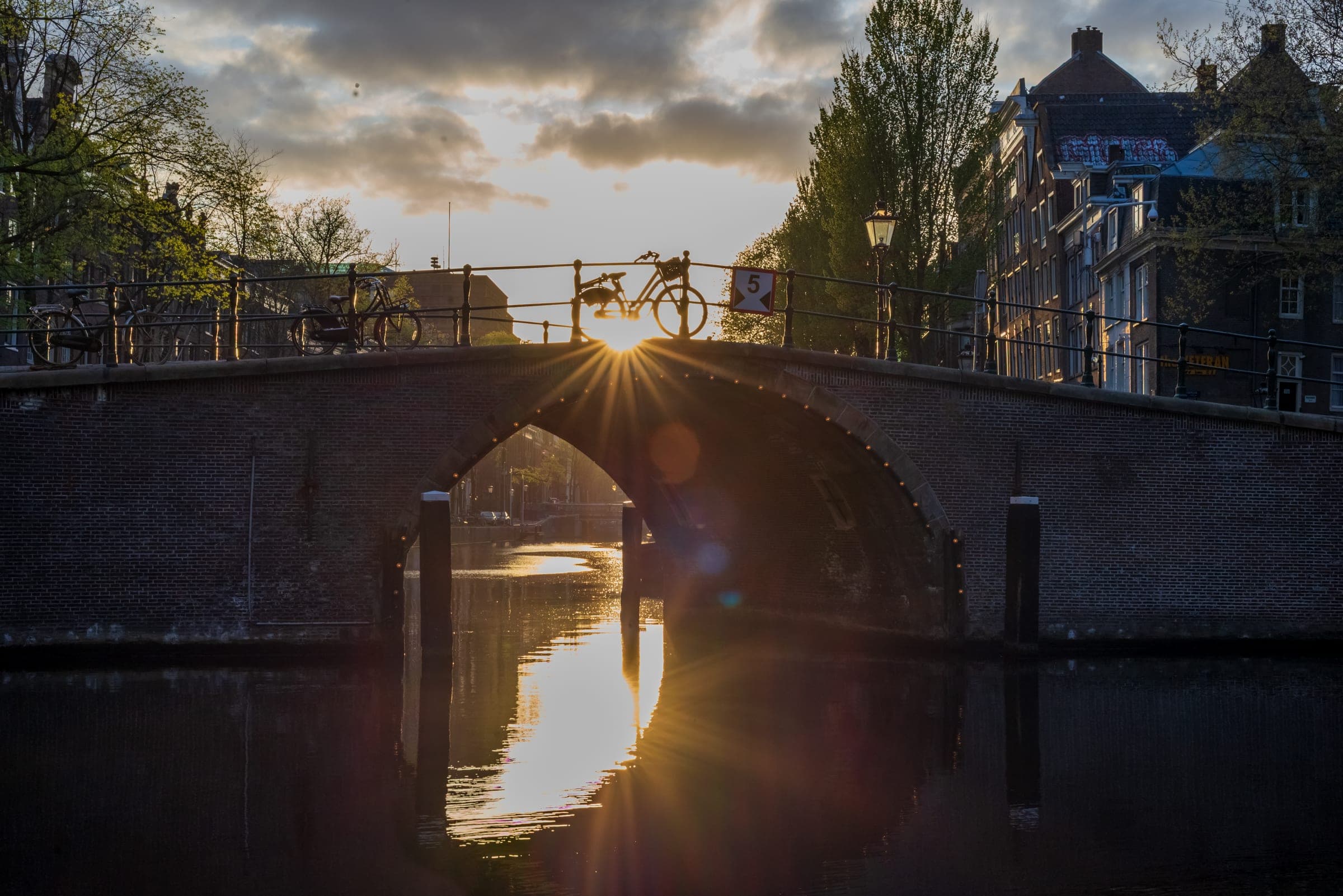 Sunburst under an Amsterdam canal bridge